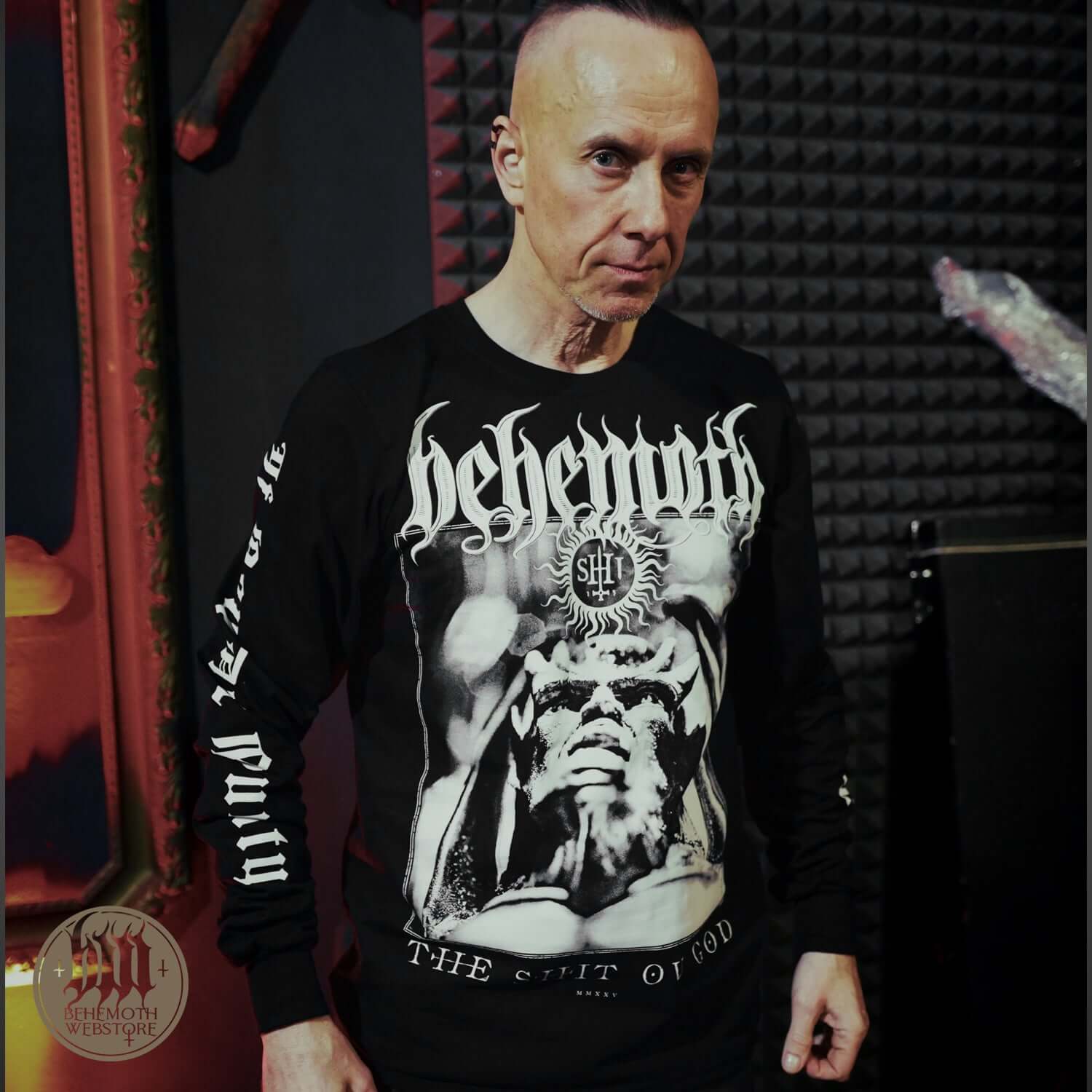 Man wearing Behemoth TSOG long sleeve shirt with band logo and graphics, featuring premium cotton construction.