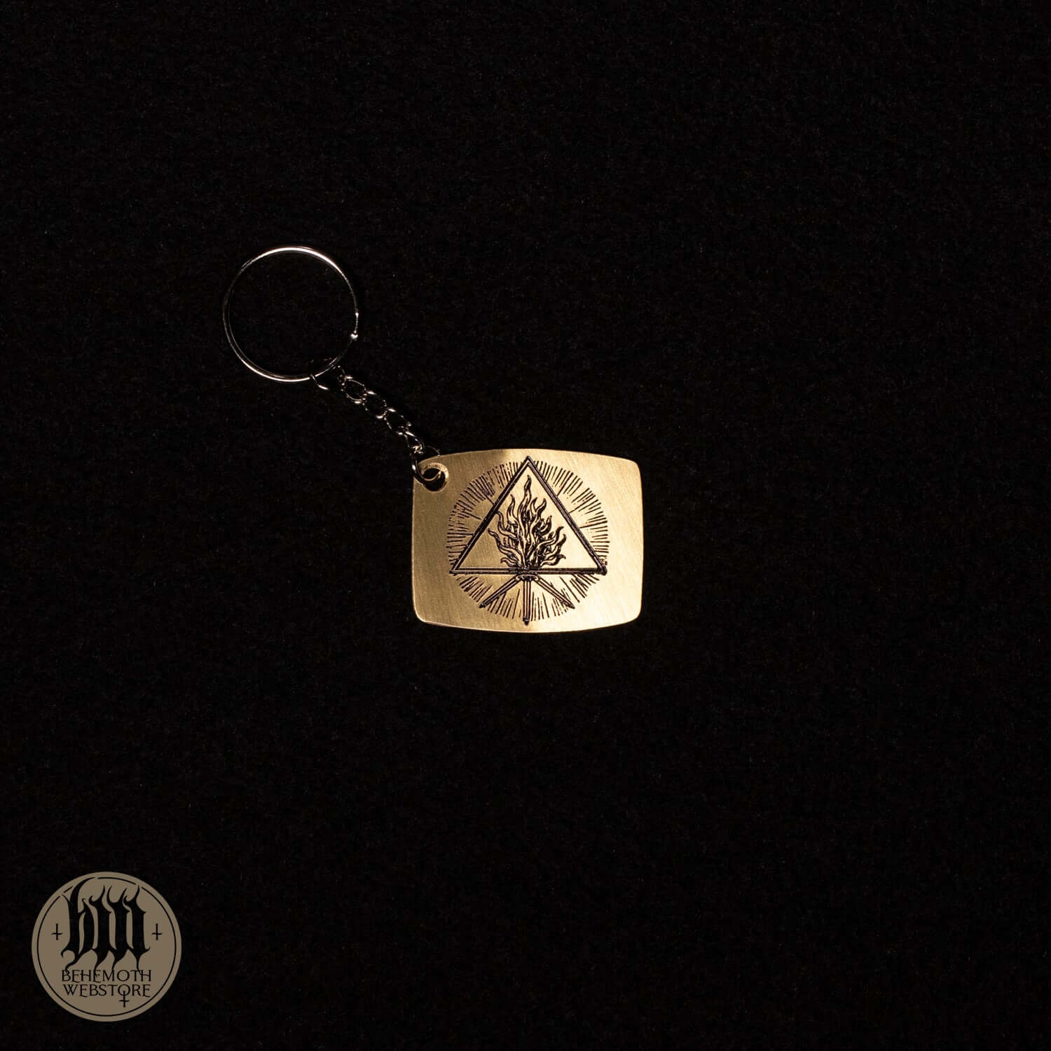 A Behemoth 'The Unholy Trinity' brass keychain with patina cover, featuring an intricate design, size 4x3.2 cm.