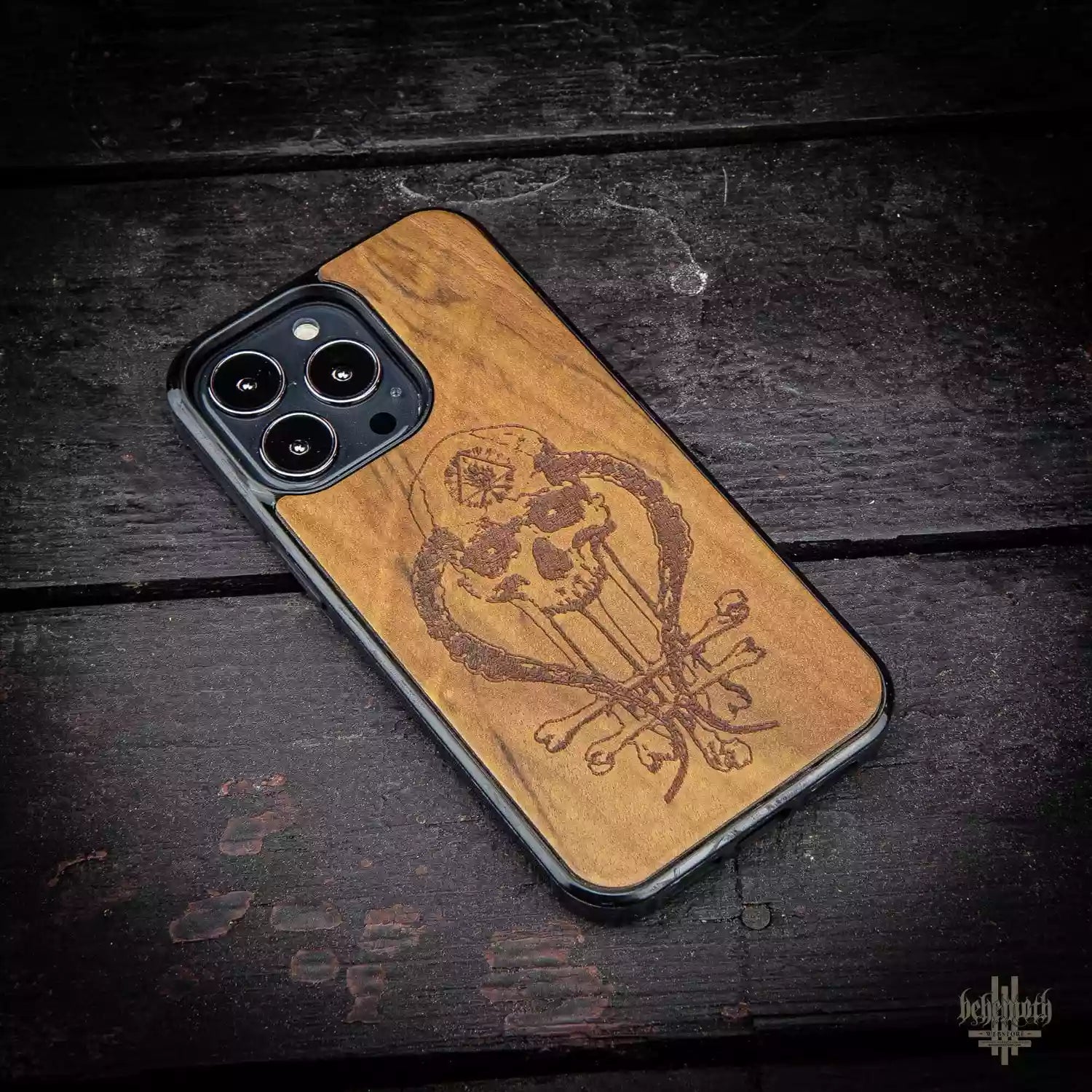 iPhone 13 Pro case with wood finishing and Behemoth 'In Absentia Dei' logo